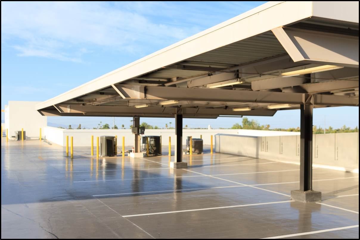 Coated and striped rooftop parking deck under a shade canopy at a Mercedes-Benz dealership