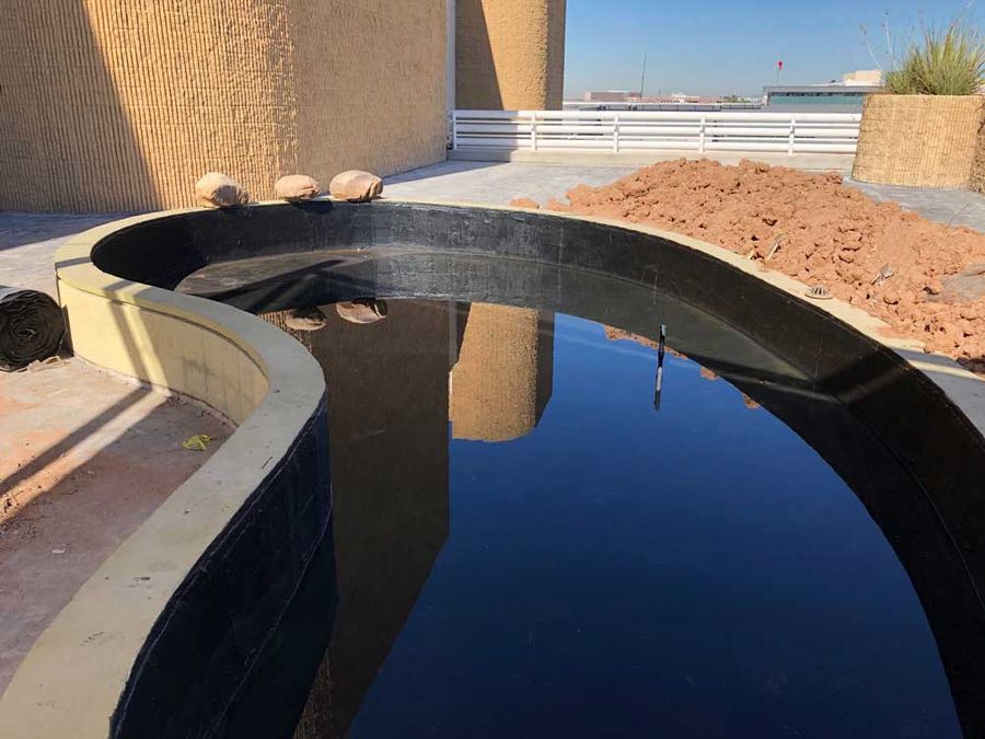 Planter lined with a black waterproofing membrane